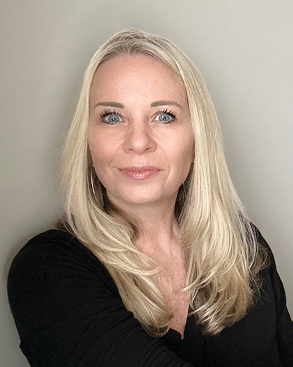 Photo of author Sherry Martin Peters who wrote ELOPE published May 2024. She is blonde with long hair, blue eyes, and wearing a solid black shirt looking straight into the camera with a smile.