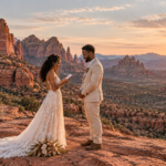 Couple exchanging wedding vows among dramatic red rocks at sunset